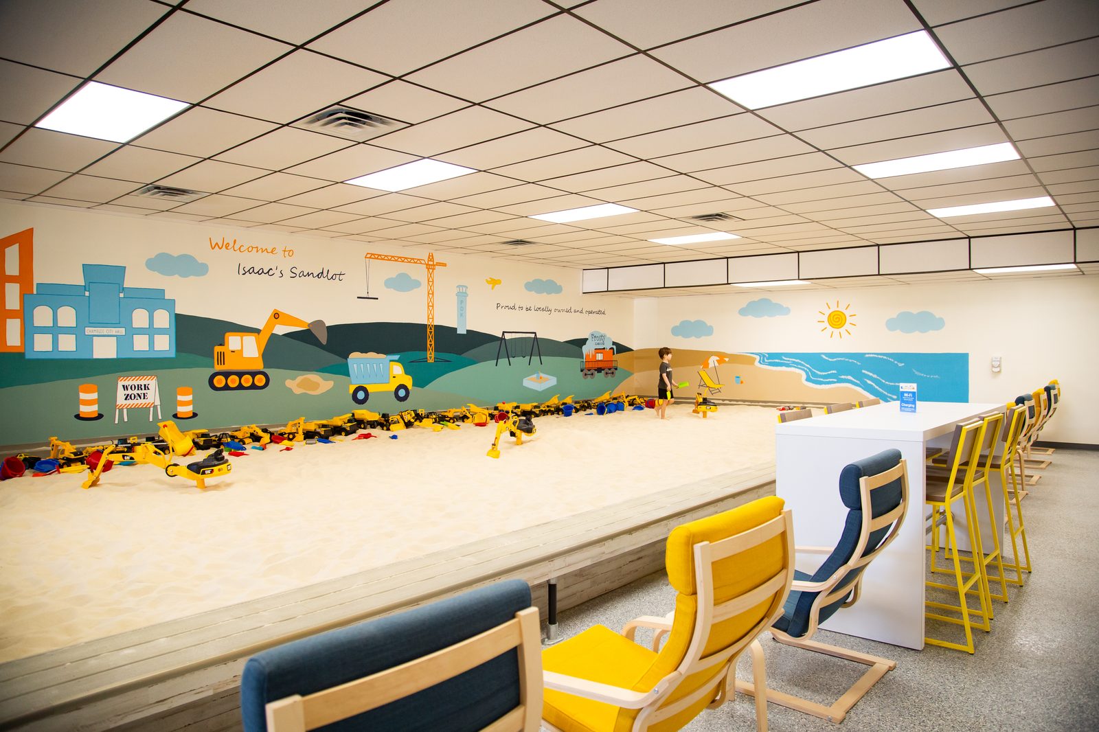 The giant indoor sandbox with mural and parent seating