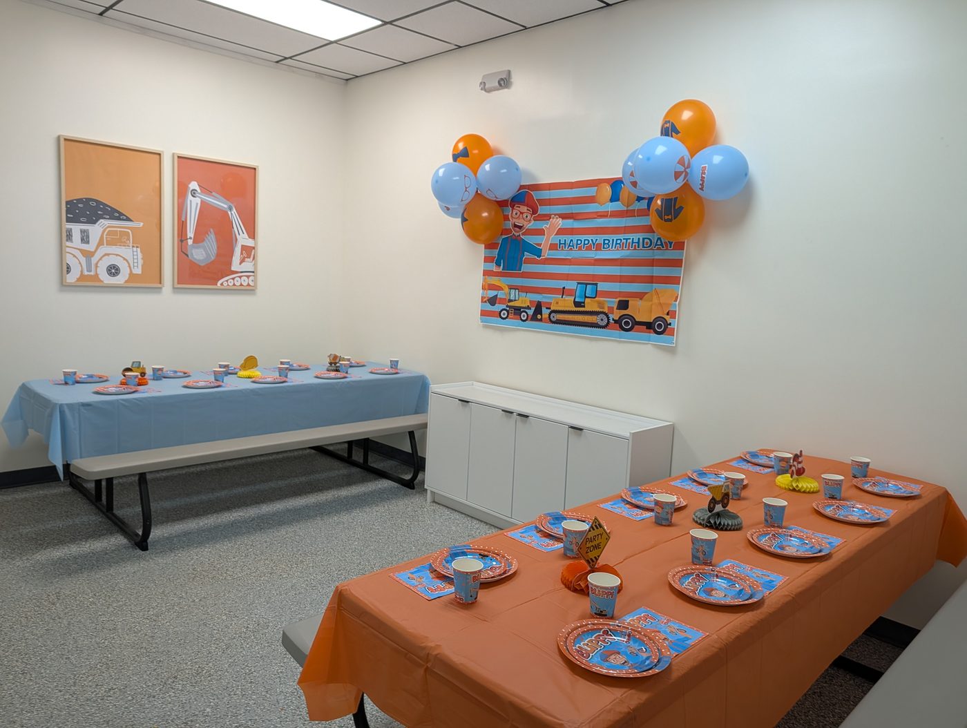 Blippi theme party room decorated in orange and blue