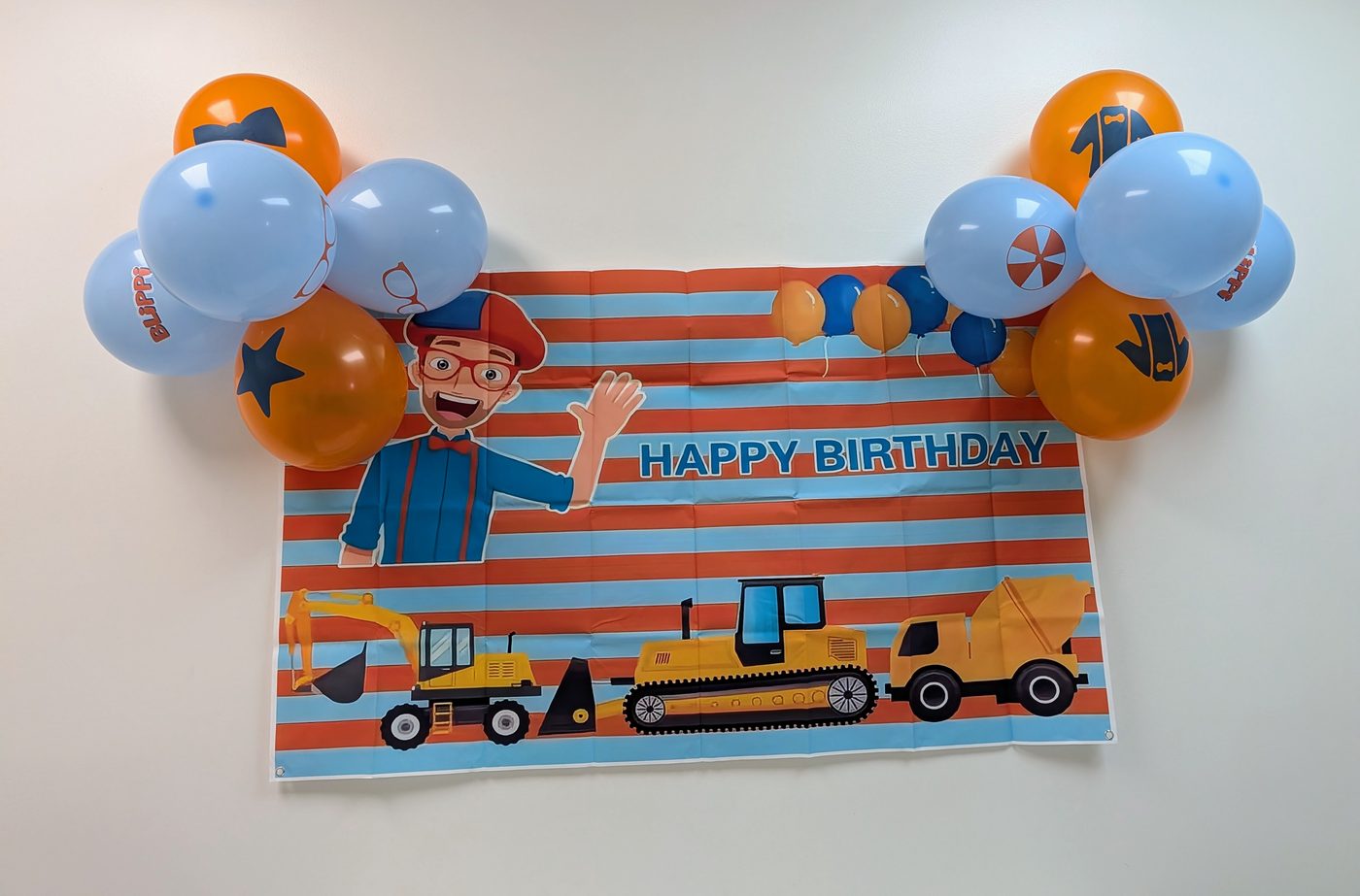 Blippi birthday banner with balloon garland